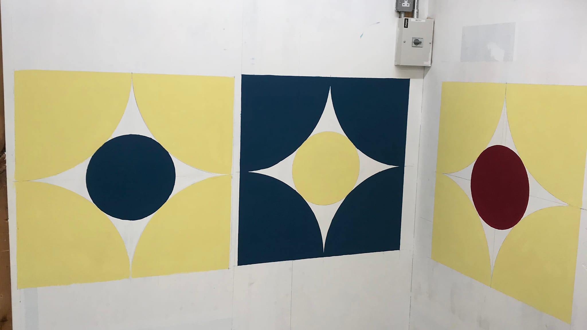 Geometric painted panels in yellow, white, navy and red